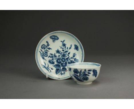 A Caughley porcelain tea bowl and saucer,circa 1775-80,transfer-printed in the Three Flowers and Butterfly pattern between a 