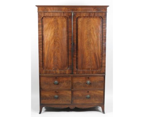 A late Regency mahogany and ebony strung linen press, early 19th century the bevelled cornice above two indented panel cupboa
