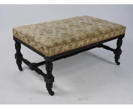 A Victorian Aesthetic Movement ebonised and incised gilt framed stool with rectangular piped brocade top raised on ring turne