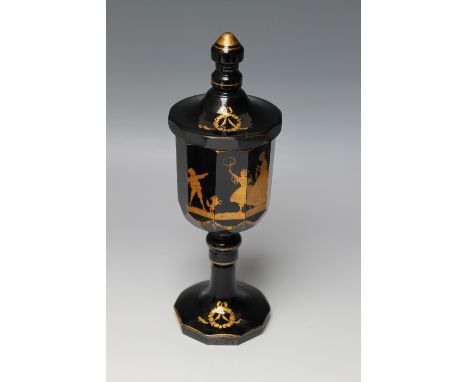 A CLASSICAL AMETHYST GOBLET AND COVER, of multi faceted form, raised on a knopped stem and plain base, stencilled in gilt wit