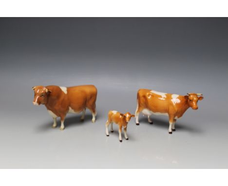 A BESWICK GUERNSEY CATTLE TRIO, the bull No 1451, the first version cow No 1248A and the calf No 1249A, designed by Arthur Gr