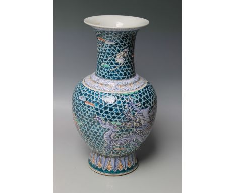 A LARGE CHINESE PORCELAIN BALUSTER VASE, decorated with two dragons and mythical winged beasts on a blue ground, bearing six 