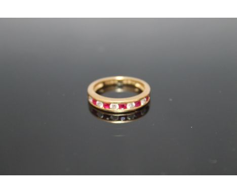 AN 18 CARAT GOLD RUBY AND DIAMOND HALF ETERNITY RING, set with approx 0.25 carat of rubies and 0.25 carat of brilliant cut di