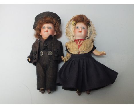 TWO MINIATURE ARMAND MARSEILLE BISQUE HEADED DOLLS, both in traditional costume, with jointed celluloid body, impressed marks