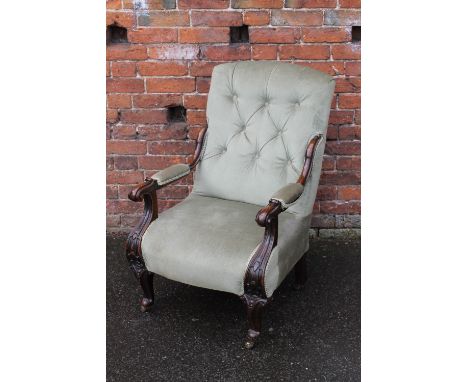 A 19TH CENTURY MAHOGANY FRAMED ARMCHAIR, with button backed upholstery, the scroll arms with carved detail, raised on shaped 