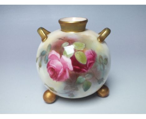 A ROYAL WORCESTER BLUSH IVORY BUD VASE, bulbous form with hand painted floral decoration, raised on three gilt bun feet, appl