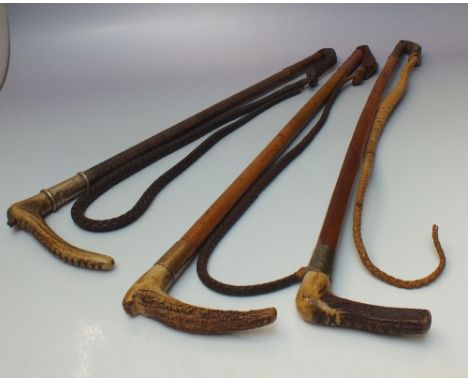 THREE BONE HANDLED HUNTING WHIPS, silver and white metal collared examples, wooden shaft with plaited leather lashes, longest