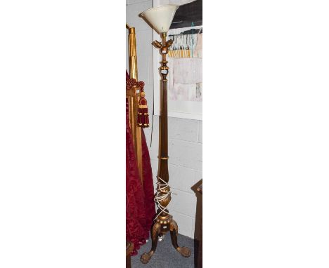 A mahogany and giltwood carved standard lamp, on a tapering reeded support with paw feet (By repute from Lowther Castle)