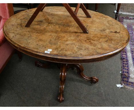 A Victorian walnut oval loo table, 88cm by 122cm by 71cm; together with a Victorian pink upholstered button back armchair (2)