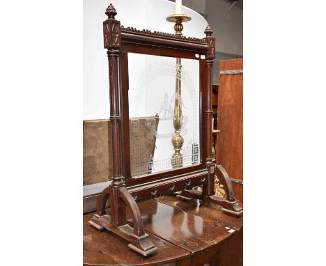 A late 19th/early 20th century glass and mahogany firescreen, the frame with Gothic carving, the glass panel etched with a cr