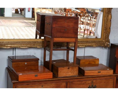 A mahogany box on stand, fitted with a drawer and lidded compartments, 32cm by 25cm by 65cm, together with six various humido