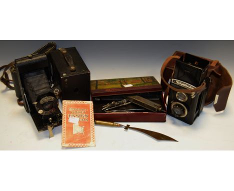 A Voightlander camera; a pocket Ensign; a box Brownie camera; Trench Art; etc