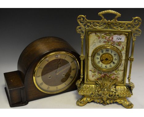 A late 19th century mantel clock with a white 8.5cm chapter ring with black Arabic numerals and pierced brass work to centre,