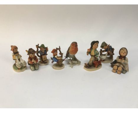 Seven Hummel figures and a Goebel bird