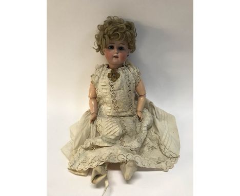 A William Goebel bisque head doll, weighted blue eyes, open mouth with five upper teeth, jointed arms and legs, impressed WG 