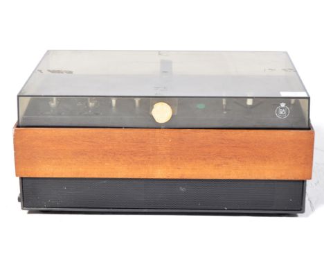 Bang and Olufsen - Beocord 1100 - A vintage reel to reel tape recorder having a smokie Perspex hinged cover and teak case. Ap