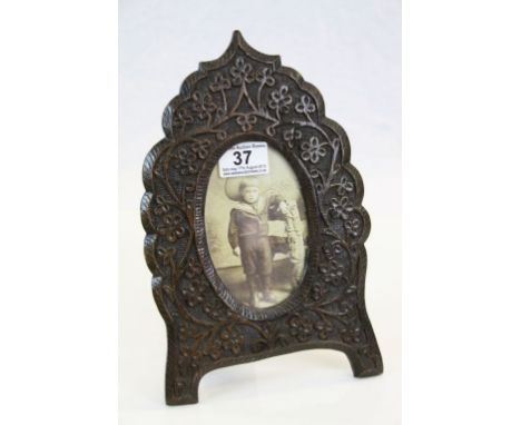 Heavily carved Oak picture frame with foliage decoration, easel style, stands approx. 27.5 cm with image aperture of approx. 
