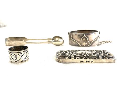 Selection of silver items includes sugar tongs, bracelet etc total weight 84 grams 