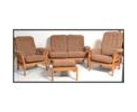 A vintage retro 20th century Ercol three piece suite consisting of settee sofa with a pair of armchairs. Also the matching fo