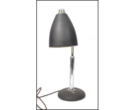 A vintage retro 20th century gooseneck goose neck anglepoise lamp raised on a heavy cast black base with chrome neck and blac