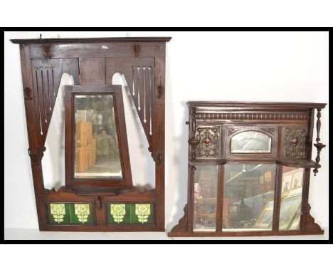 A Victorian mahogany and tile hanging coat stand rack with central mirror and green tiles surrounded by hooks together with a