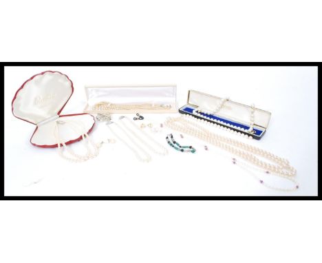 A group of faux and real pearl necklaces and jewellery mostly in boxes. brooches necklaces, earrings etc.
