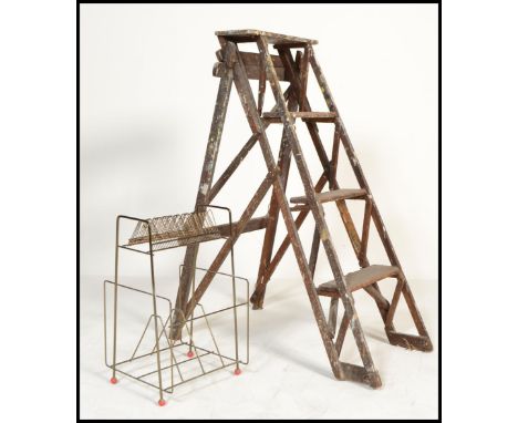 A good early 20th century Industrial lattice worked / side step ladder. Of A- frame folding form with good lattice sides.  Me