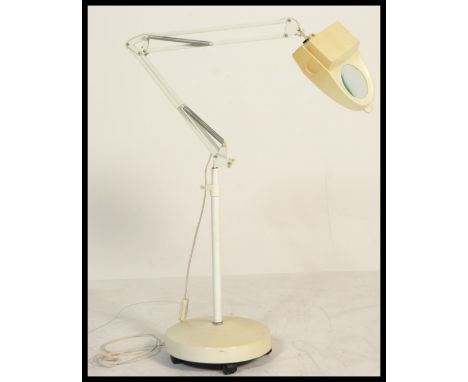 A vintage 1970's floorstanding dentists / medical anglepoise lamp with inset magnifying glass. Raised on terraced base with a