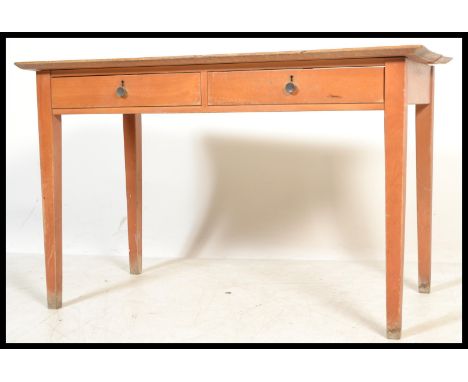 A vintage retro mid 20th century beech FSA desk having twin drawers raised on tapering square supports with red FSA stamp. Me