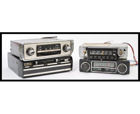 A group of four vintage car radio receivers to include an 8 Track player, Philips etc please refer to images.