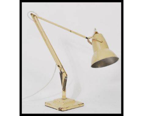 A vintage 20th century 1940's pre war Herbert Terry anglepoise industrial desk lamp raised on a stepped square base with coni