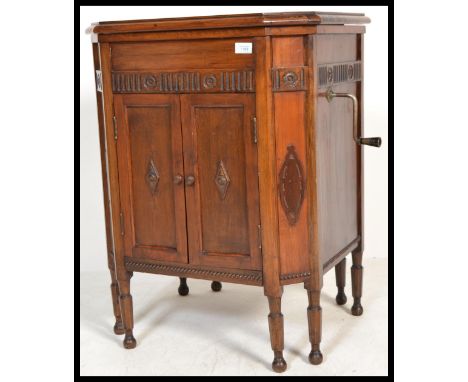 A vintage early 20th century oak cased gramophone music cabinet by Gilbert with side arm winder. Please see images.