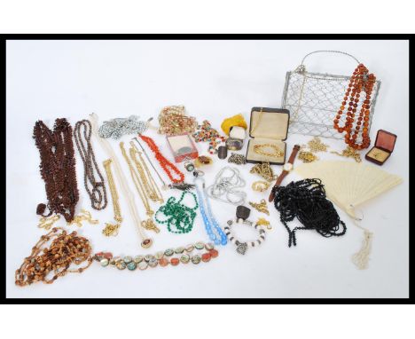 A large collection of vintage costume jewellery to include glass bead necklaces, Miracle dress clips, pearl necklaces, watche