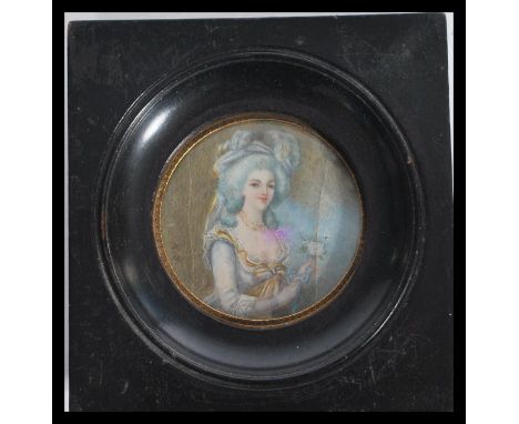 A 19th century portrait miniature painting on ivory of lady wearing blue attire wearing a blue wig. Set to a silhouette frame
