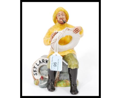Two Royal Doulton ceramic figurines The Lobster Man HN2317 and The Boatman Skylark HN2147. Measures 8ms high.