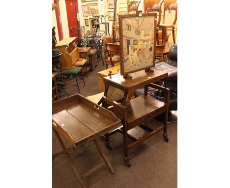 Campaign rocking chair, oak butlers tray and stand, adjustable oak dinner wagon and needlework panel firescreen (4)