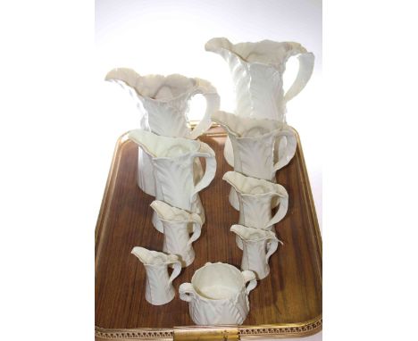 Eight graduated Royal Worcester leaf design jugs and a two-handled bowl