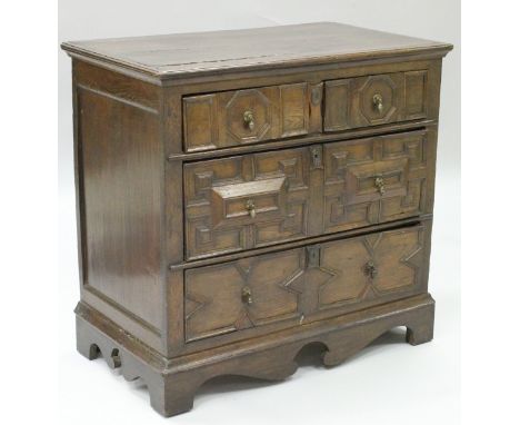 A 17th Century oak chest, the plank top with applied moulded edge over two short and two long with applied moulded decoration