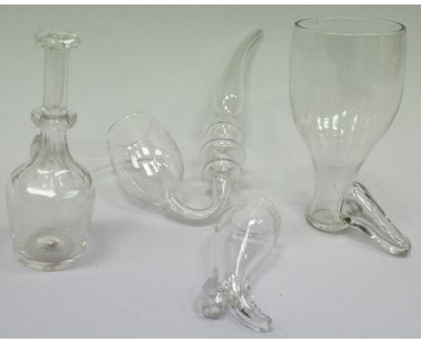 A 19th Century facet cut glass toddy lifter of mallet form, 13 cm high, together with a plain glass stirrup cup of boot form,