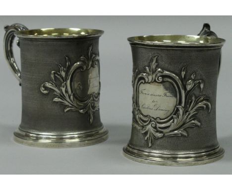 A pair of early Victorian silver tankards with scroll handle, textured body and acanthus decorated cartouches, one inscribed 