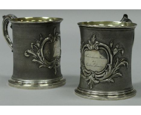 A pair of early Victorian silver tankards with scroll handle, textured body and acanthus decorated cartouches, one inscribed 