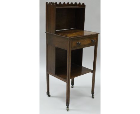 A 19th Century mahogany side table with three quarter galleried swivel top above the inlaid and cross banded main surface abo