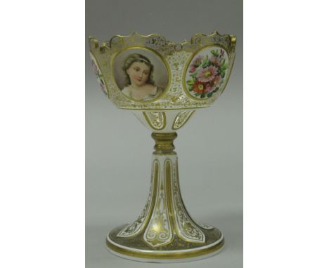 A 19th Century Bohemian overlaid enamelled and gilt decorated table centre, the castellated rim bearing three oval portrait m