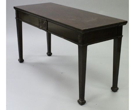 A circa 1900 mahogany serving table in the Adam taste, the plain top with carved edge over a plain frieze with central urn pa
