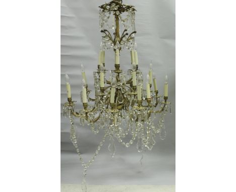 A 19th Century gilt brass twenty-four light, three tier chandelier in the Louis XV taste with glass drops (converted to elect