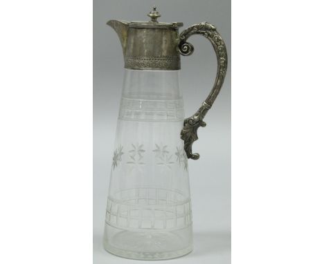 A late Victorian silver mounted cut glass claret jug, the silver mounts sets with engraved C scroll decoration and acanthus d