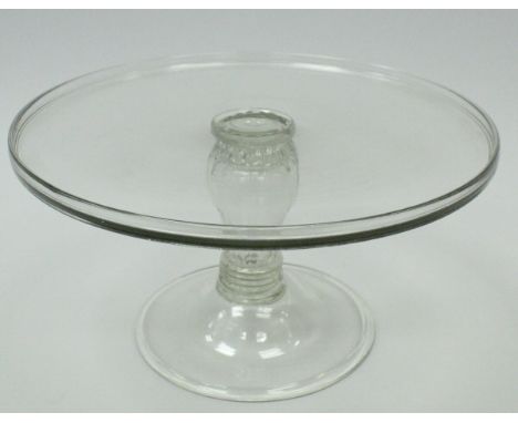 A late 18th / early 19th Century glass tazza of plain form, the circular top raised on a ribbed baluster pedestal with ringed
