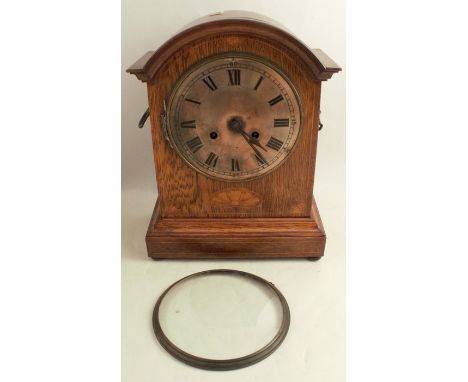 An oak cased chiming mantel clock, with silvered dial, the movement marked PHS for Peter Haas &amp; Son, with inlaid decorati