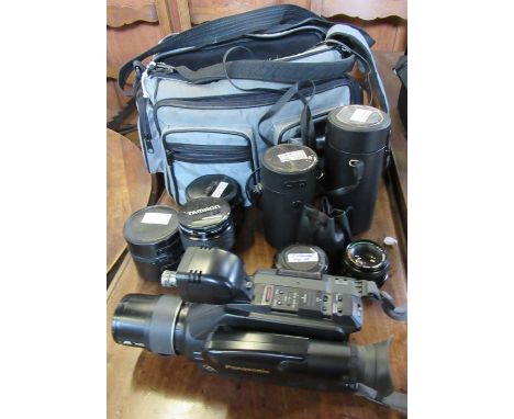 A collection of lenses, together with a Panasonic video camera