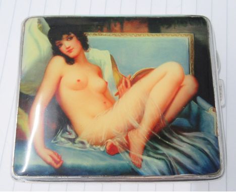 A white metal cigarette case, with engine turned decoration and a panel of a naked&nbsp; woman&nbsp;